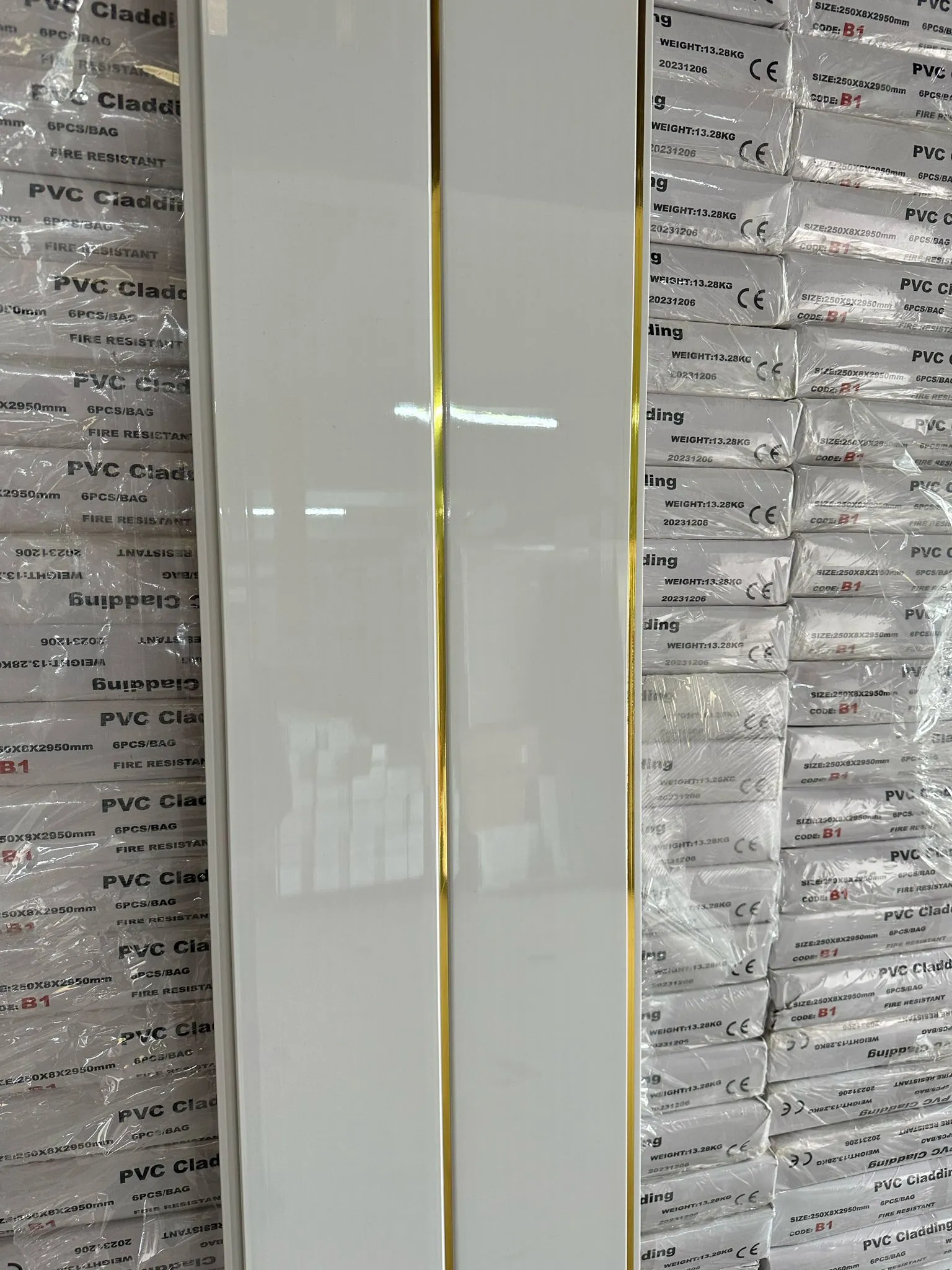 A tall white cabinet sitting next to a pile of boxes.