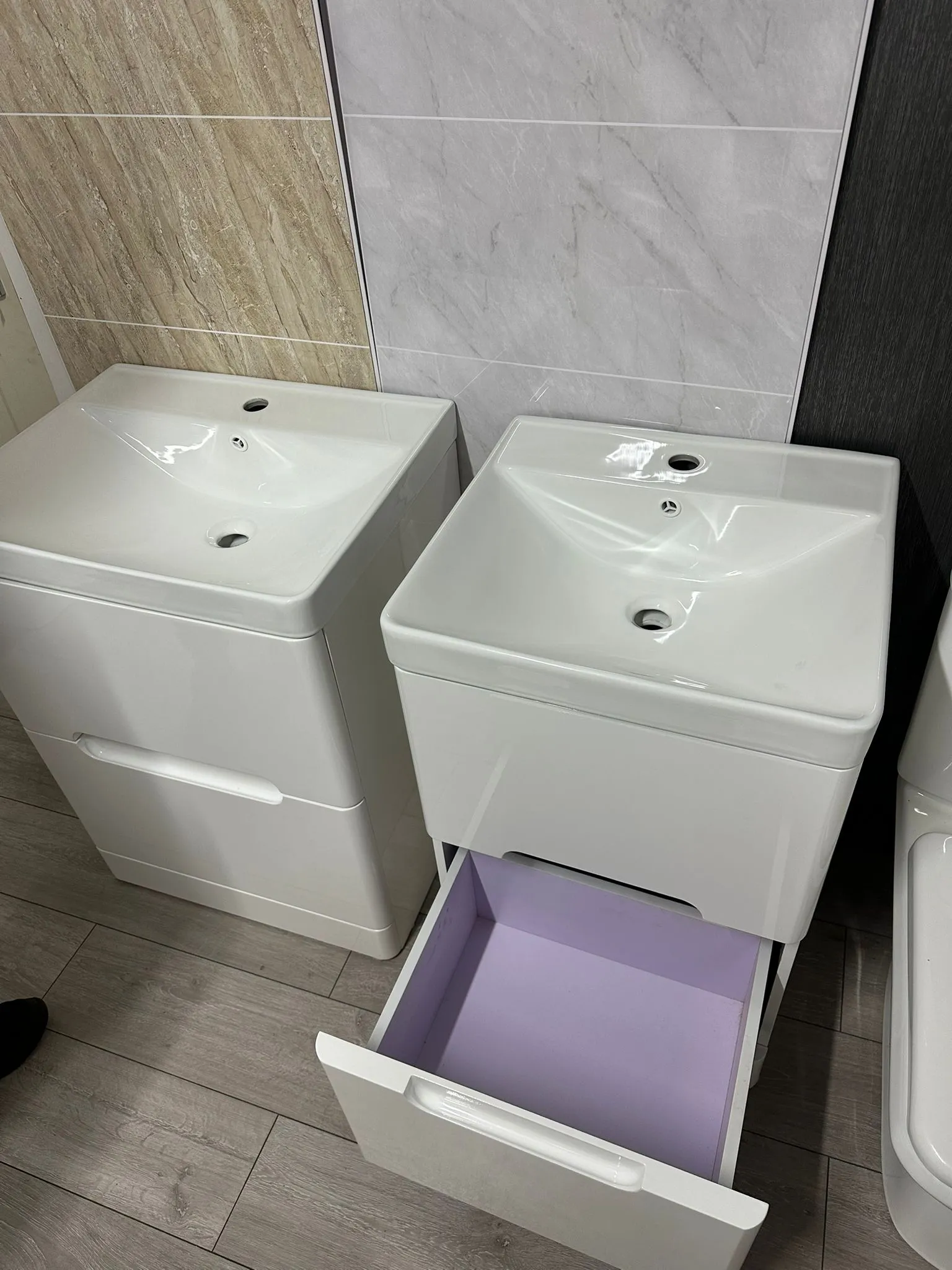a bathroom with two sinks and a toilet